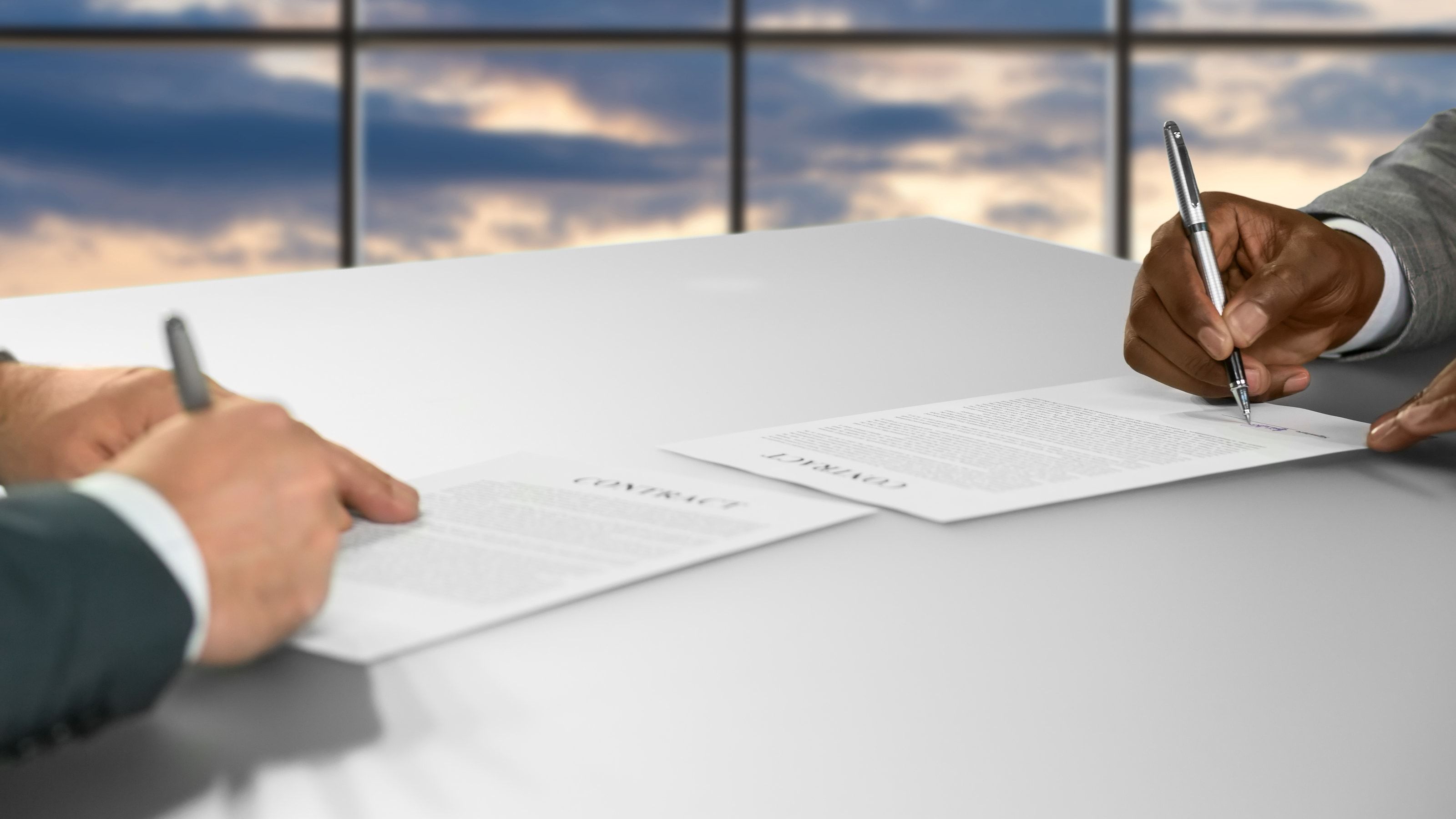 Firma de un documento sobre una mesa de oficina